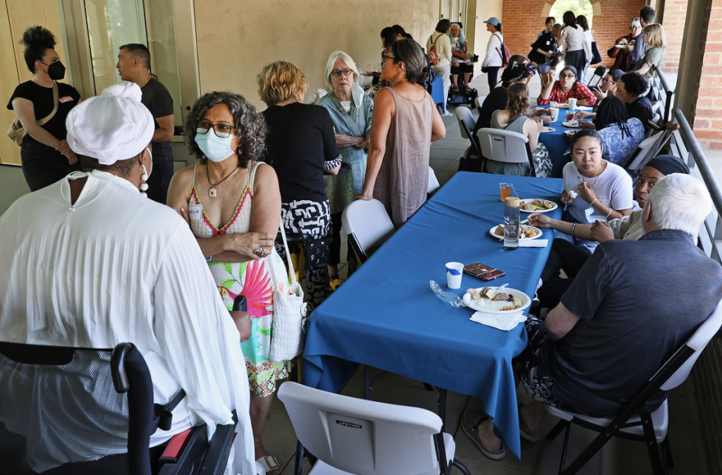 DEPE participants and artists gather outside to engage in conversation